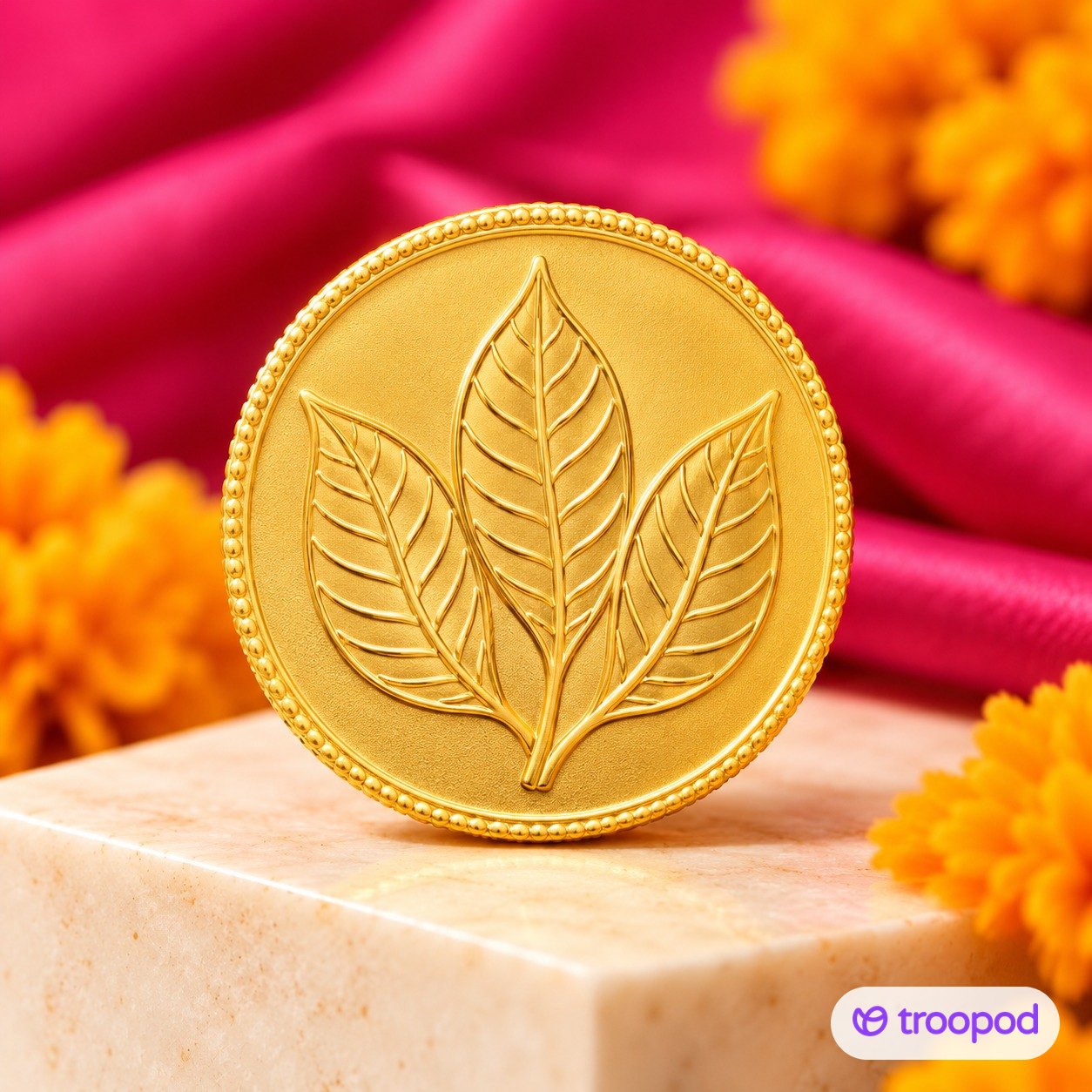 Gold coin on a marble block with marigolds